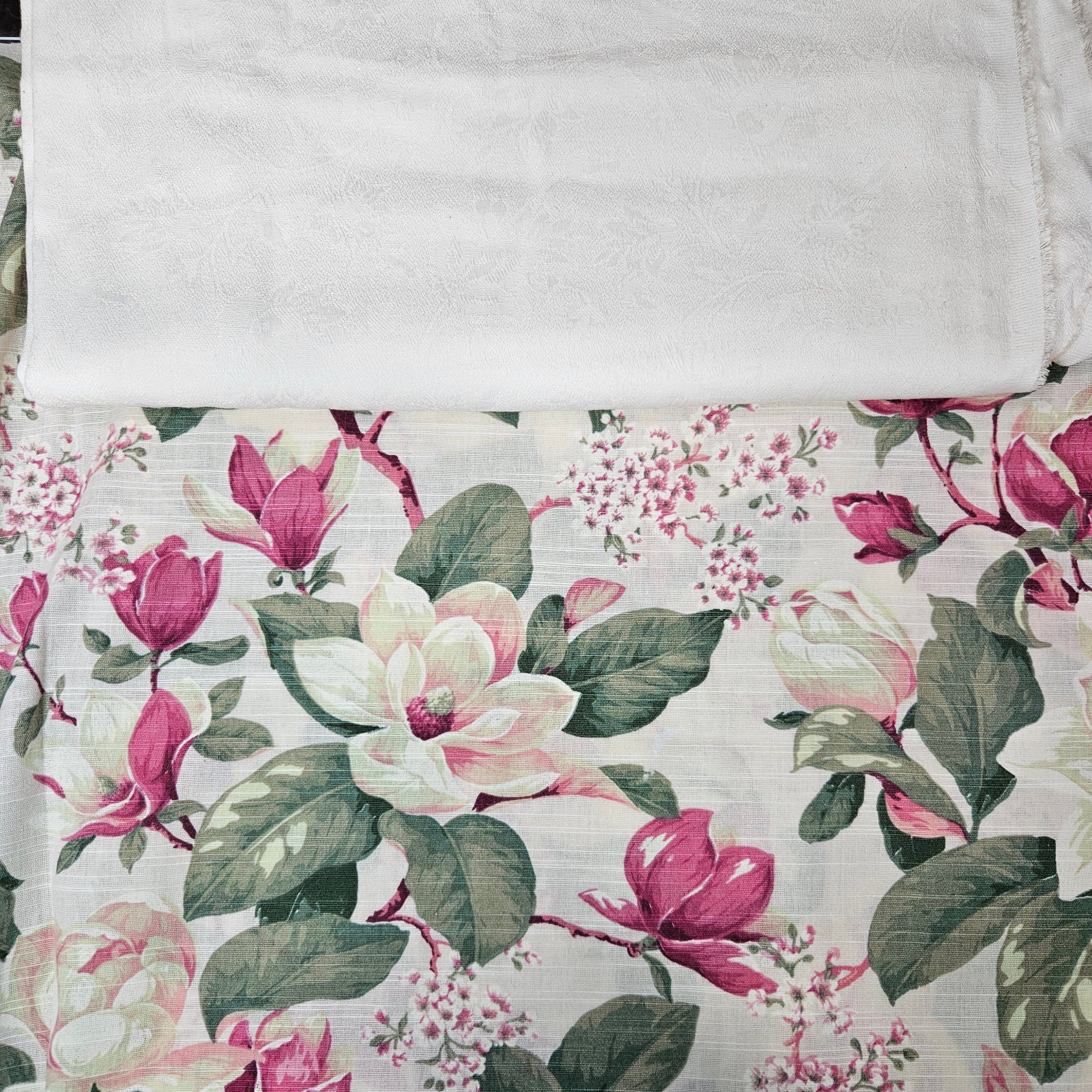 Floral fabric with pink and green flowers on a ivory background