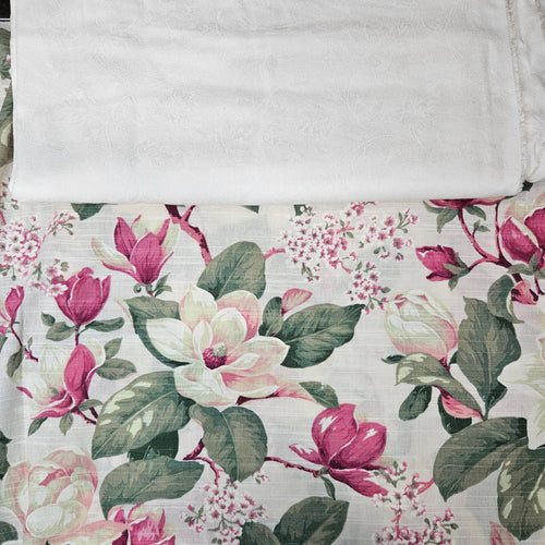 Floral fabric with pink and green flowers on a ivory background