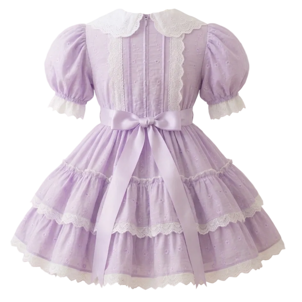 A lavender eyelet sissy dress with white lace on a white background
