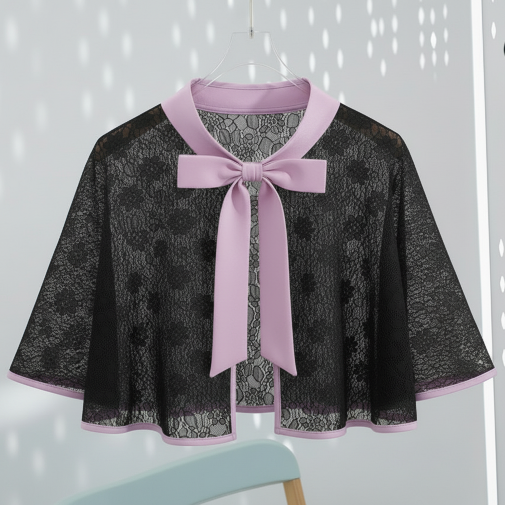 Black lace cape with lavender bow against a light gray background 