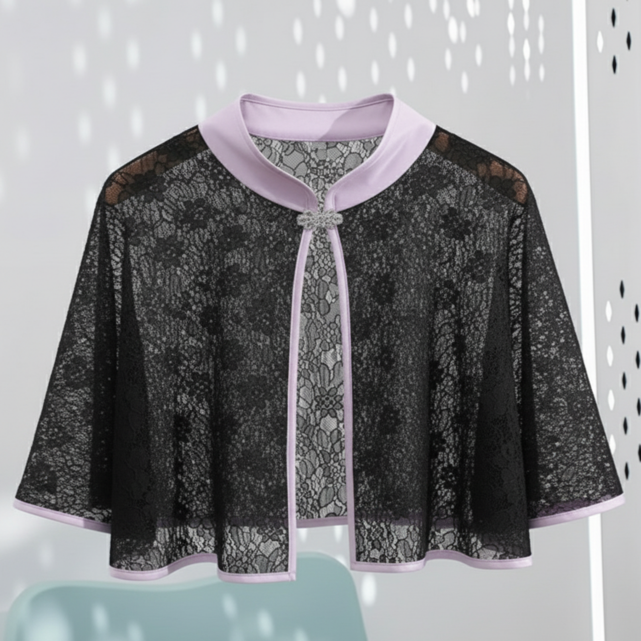 Black lace cape with Lavender trim on a light gray background