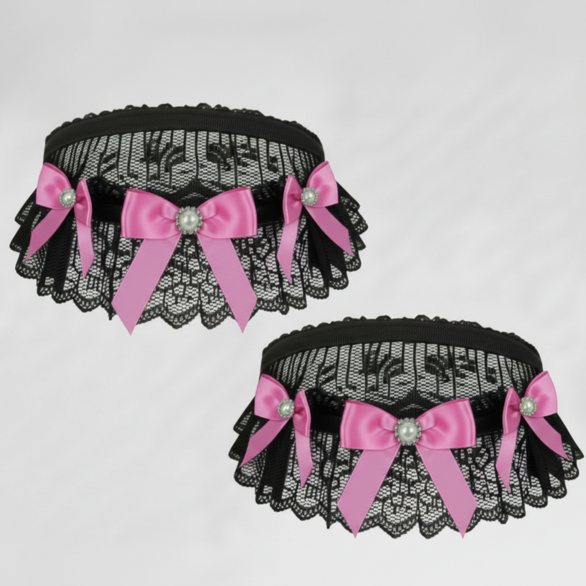 Black lace choker & garter with pink satin bows and decorative elements on a light gray background