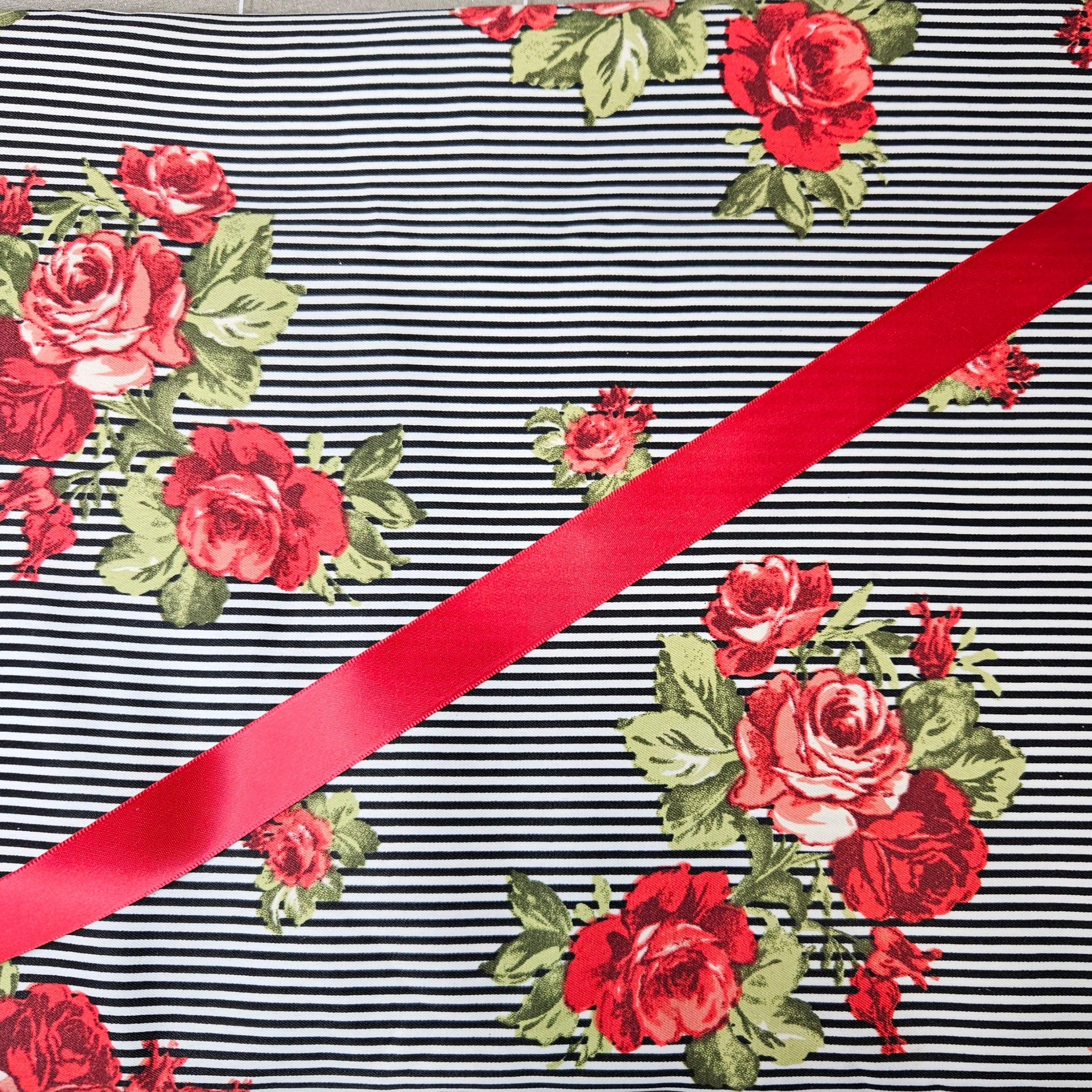 Striped fabric with red roses and a red ribbon