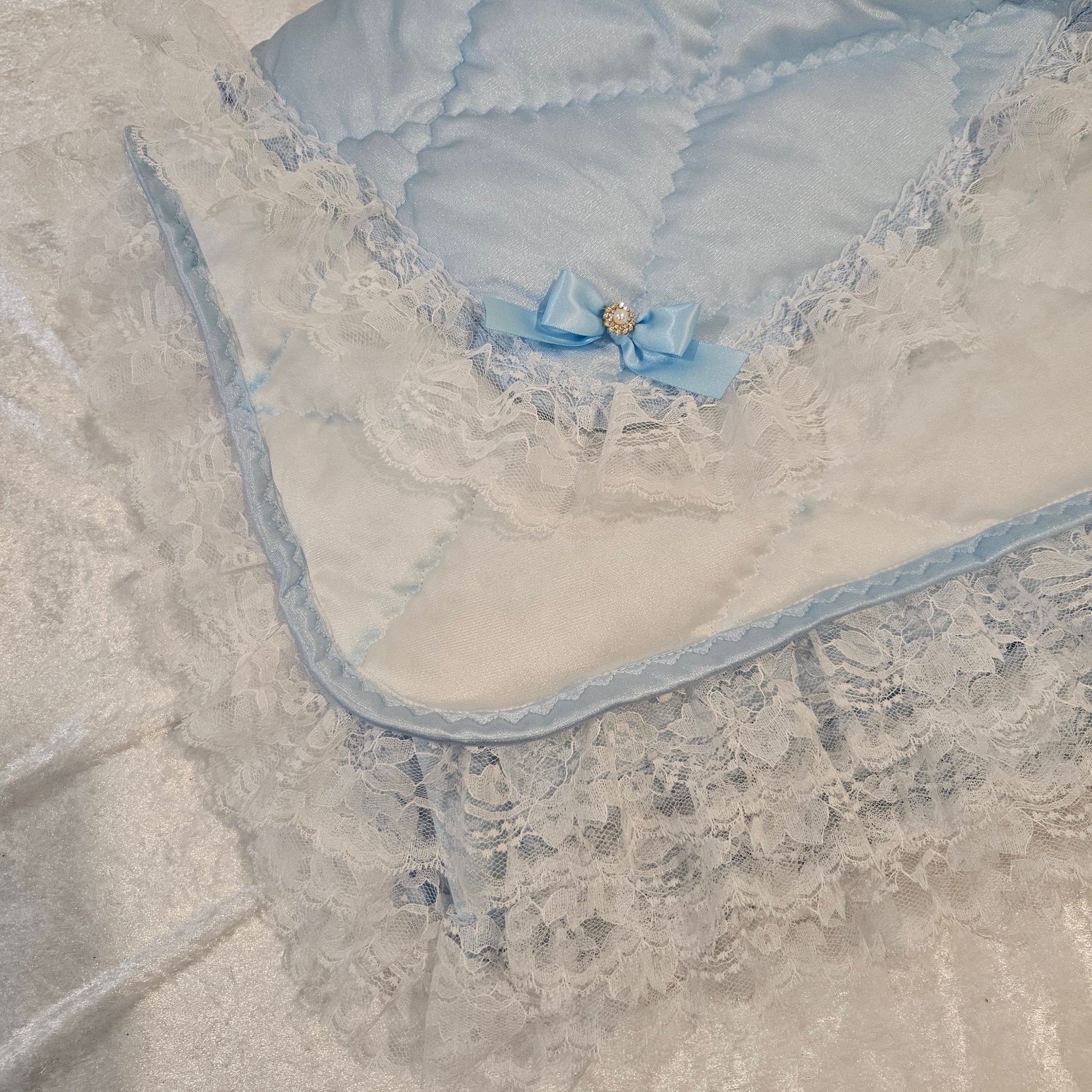 A blue bow on a snuggle blanket fabric background