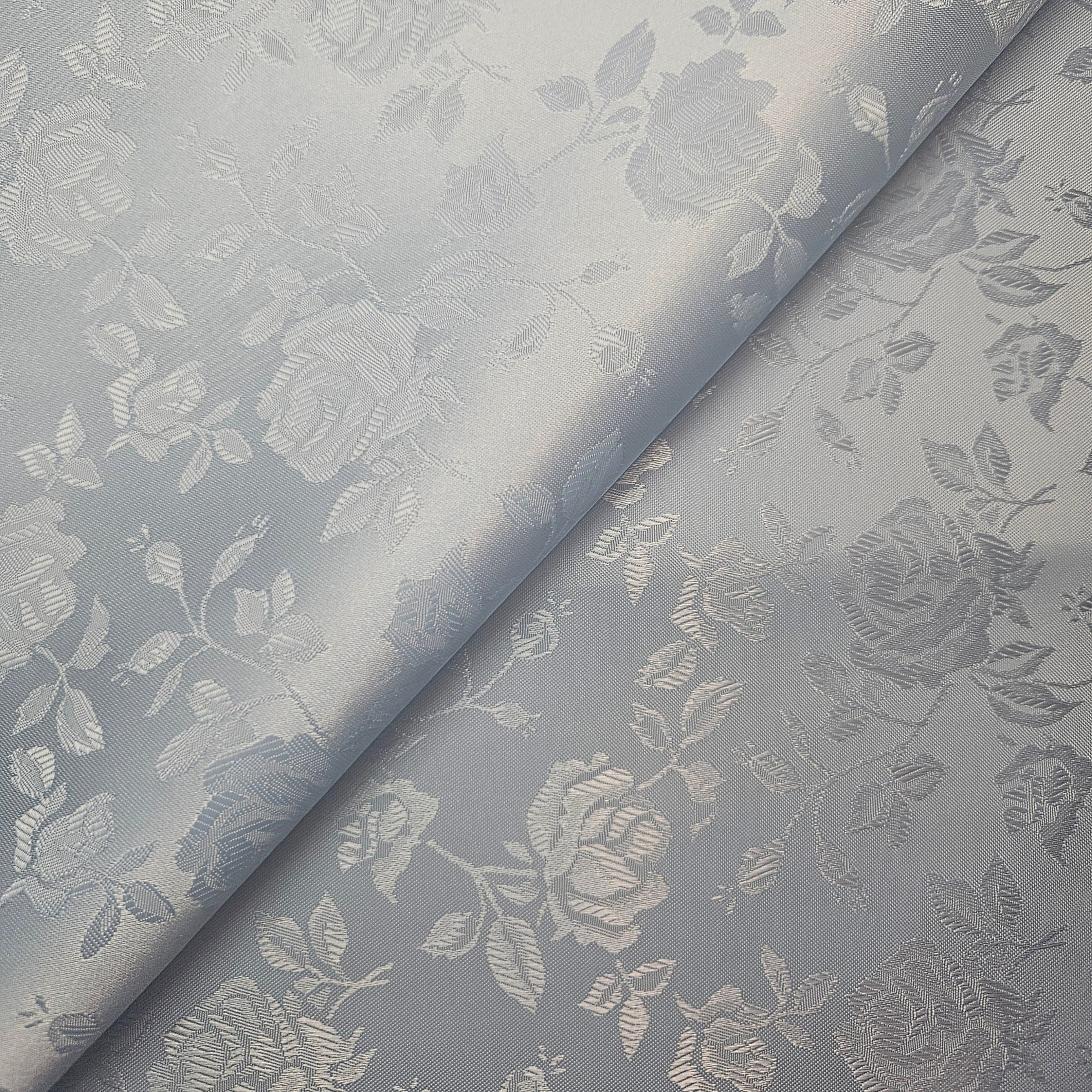 Floral patterned brocade fabric with roses on a blue background