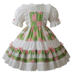 A green and pink floral Lolita dress with white lace trim and puff sleeves, displayed on a mannequin torso against a plain white background.