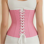 Person wearing a pink corset over a white tank top against a neutral background