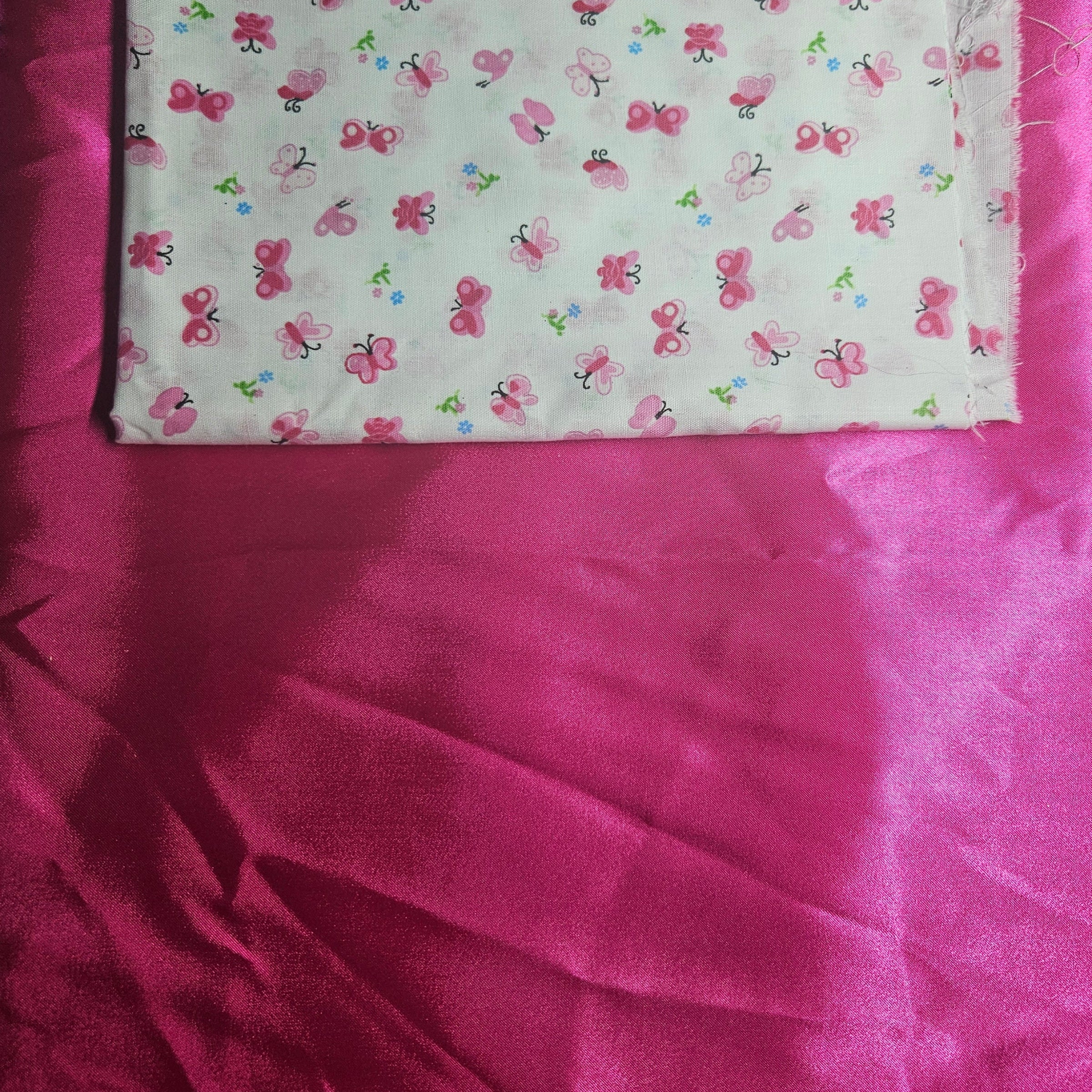 hot Pink satin fabric with butterfly pattern on a pink background