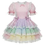 A pastel Lolita-style dress with a pink bodice, short puff sleeves, and a tiered skirt in pink, purple, green, and yellow with white lace trim.