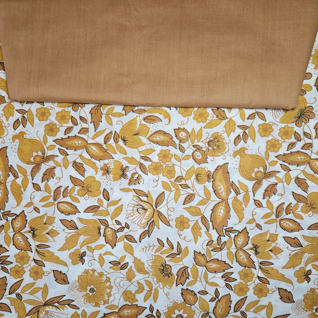 Brown fabric with yellow floral pattern on a white background