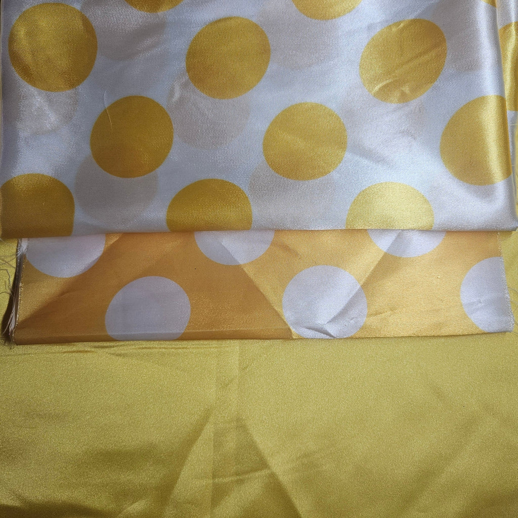 White fabric with golden yellow polka dots on a yellow background