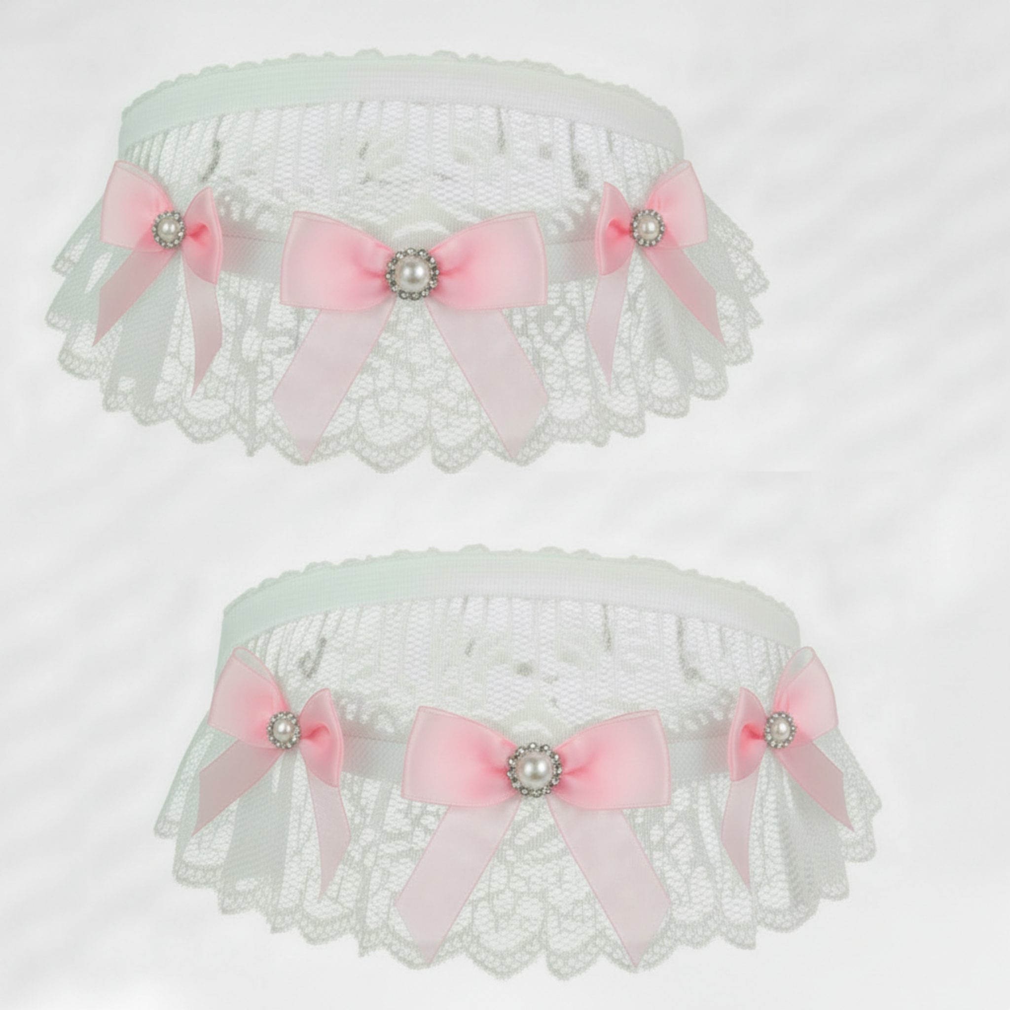 Two white lace garters with pink sheer bows and decorative elements on a light gray background