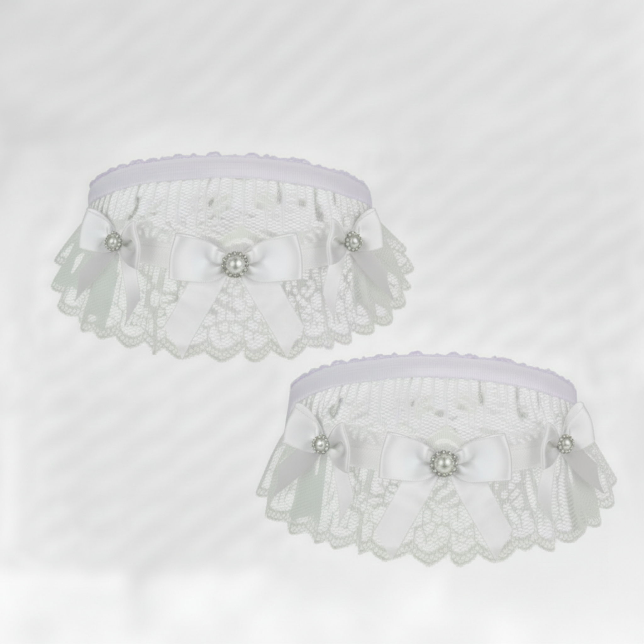 White lace garters  with white satin ribbon bows on a white background