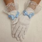 White gloves with lace cuffs and blue bows on a neutral background