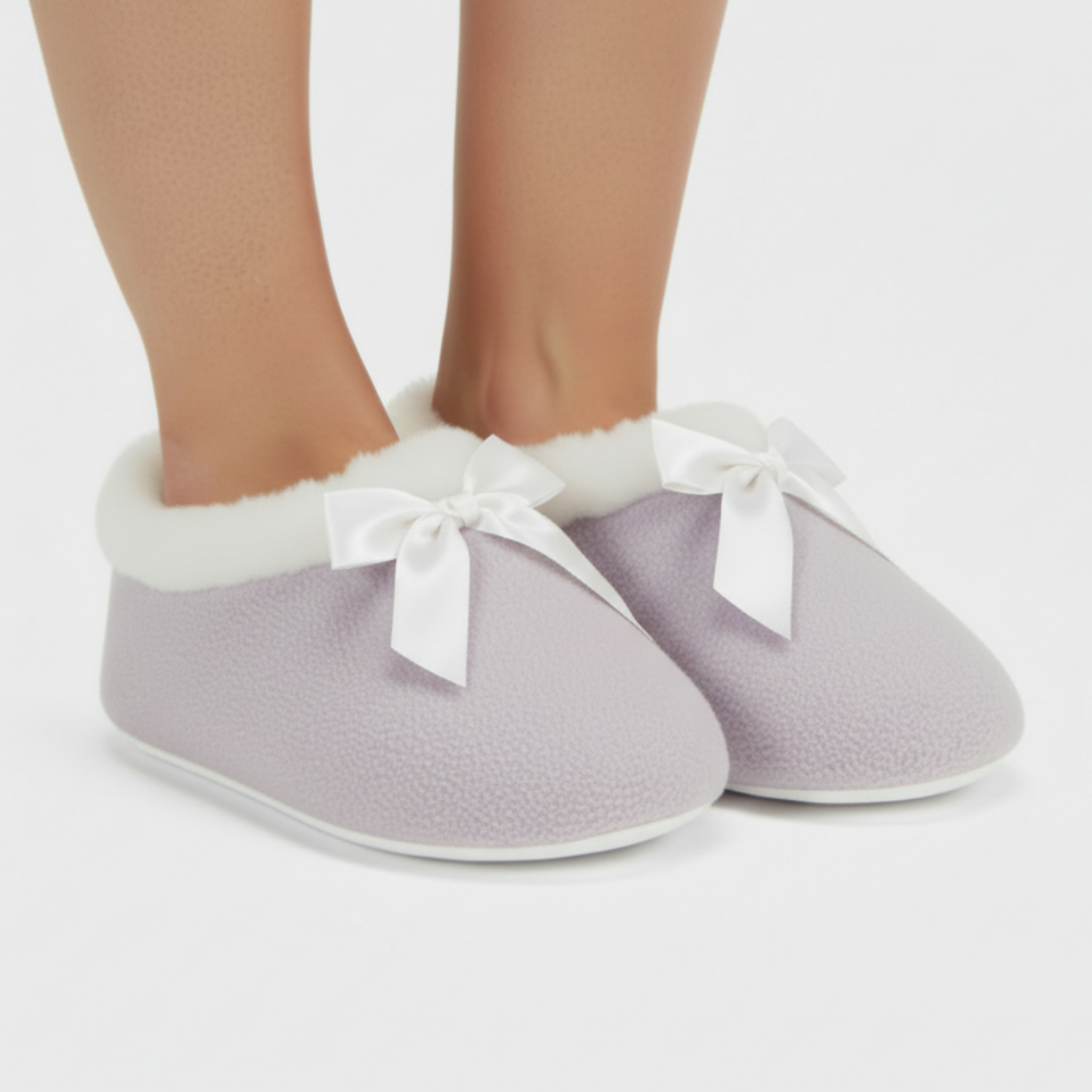 Lavender fleece slippers with bows on a white background