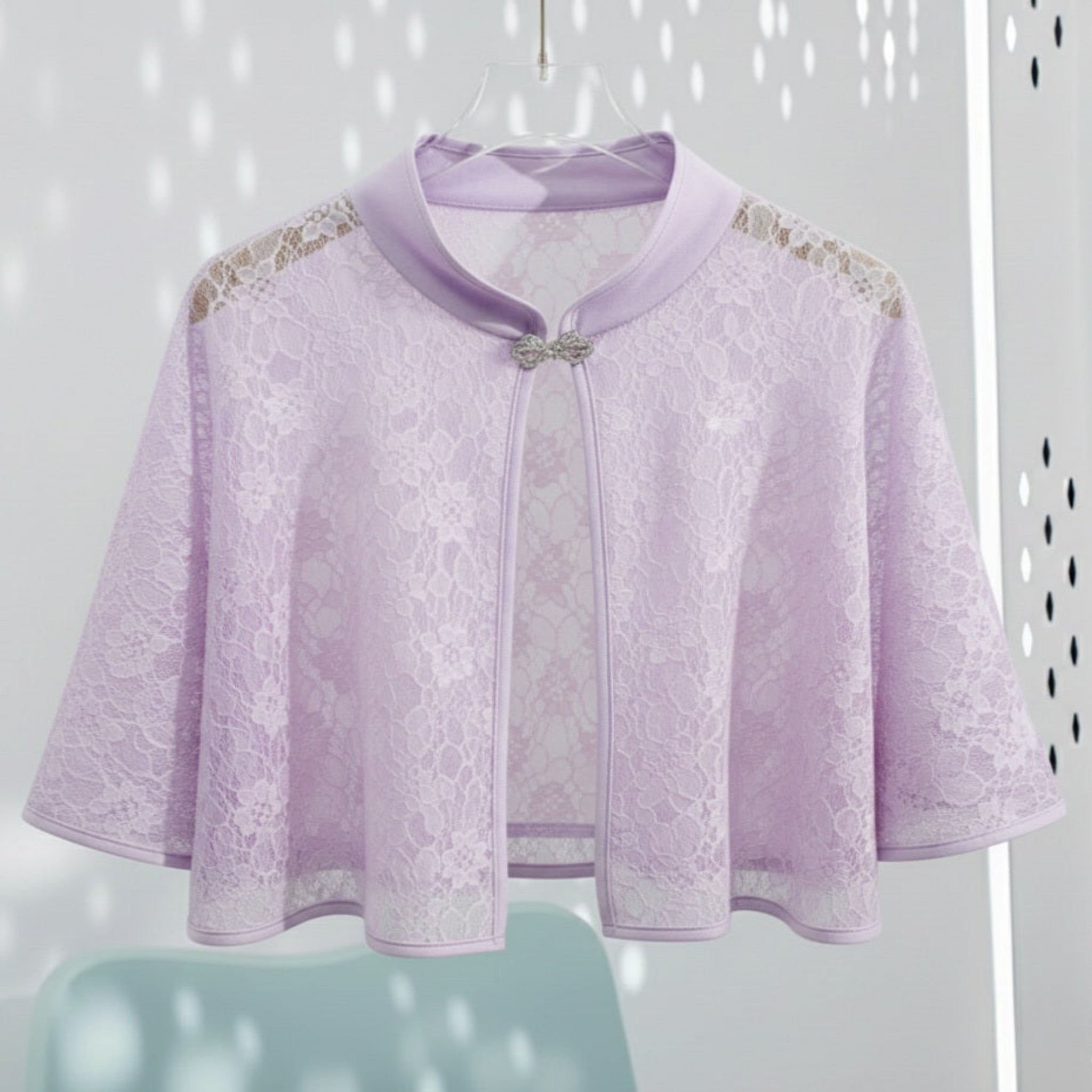 Lavender lace cape with a bow on a white background