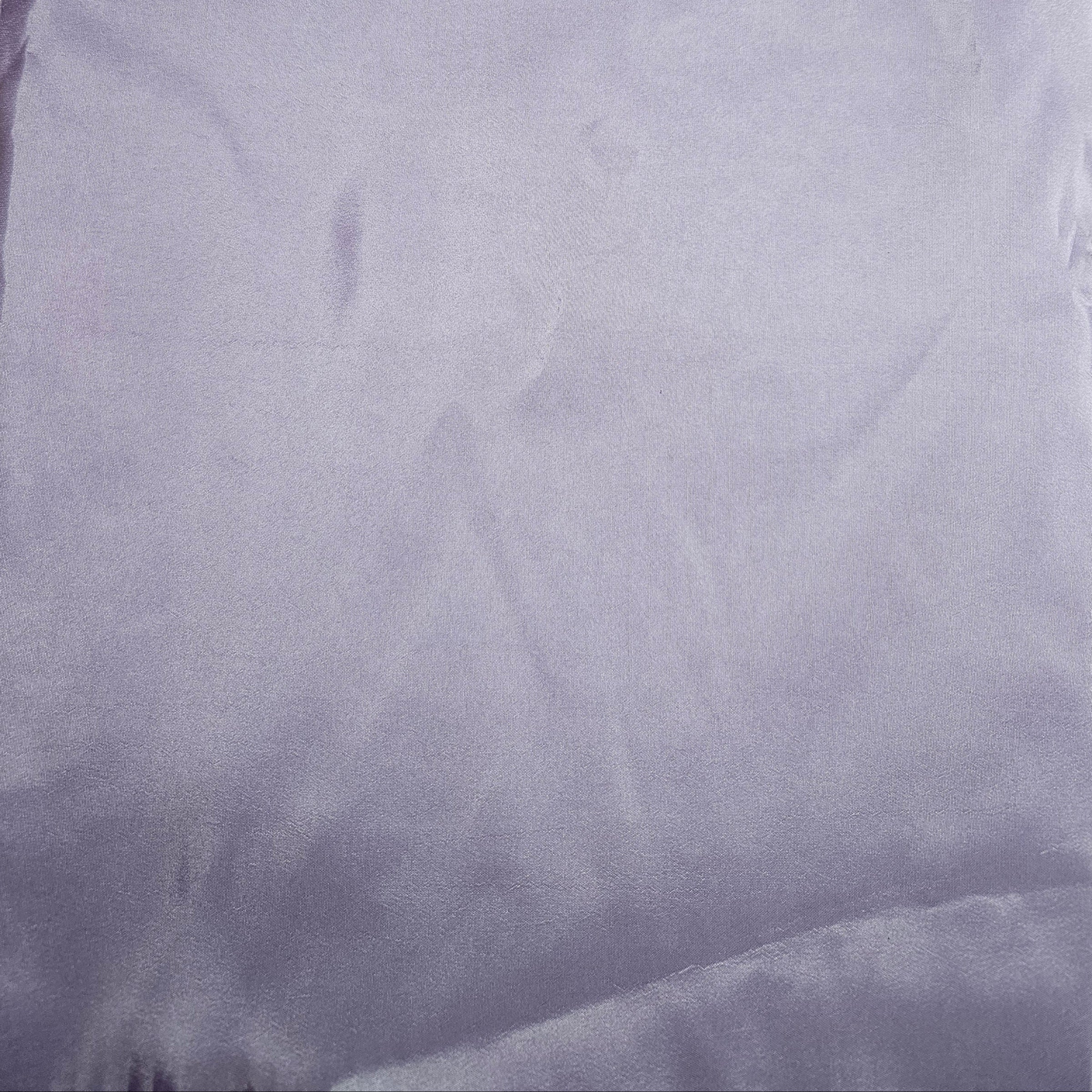 Close-up of a textured lavender taffeta fabric surface