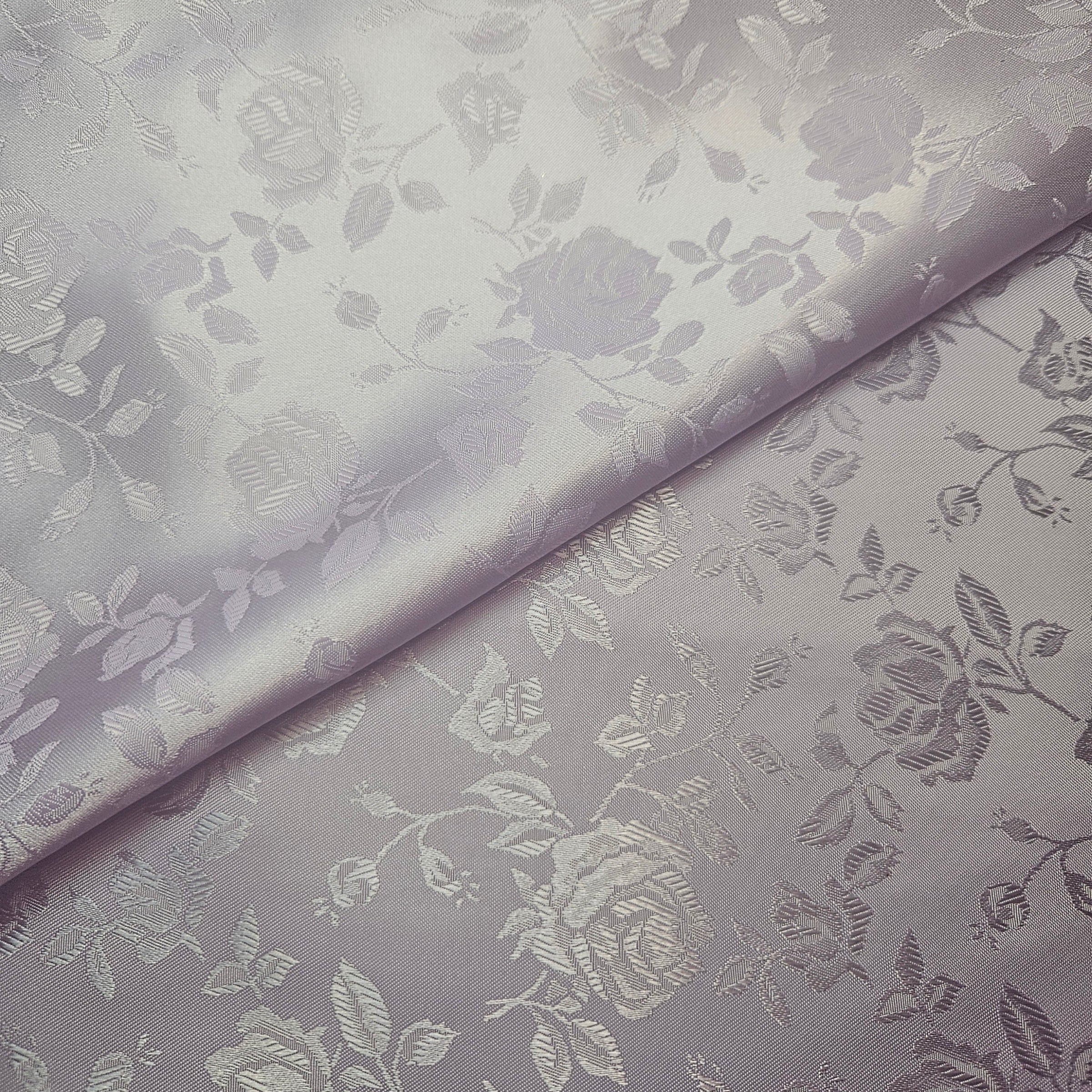 Floral patterned brocade fabric with a subtle design on a lavender background
