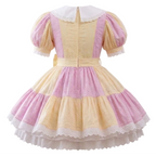 A pink and yellow eyelet sissy dress on a plain white background