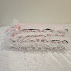 Close-up of a white lace snuggle blanket with a plain background