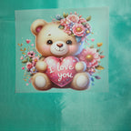 Illustration of a teddy bear appilque holding a heart with 'I love you' text, surrounded by flowers on a teal taffeta background.