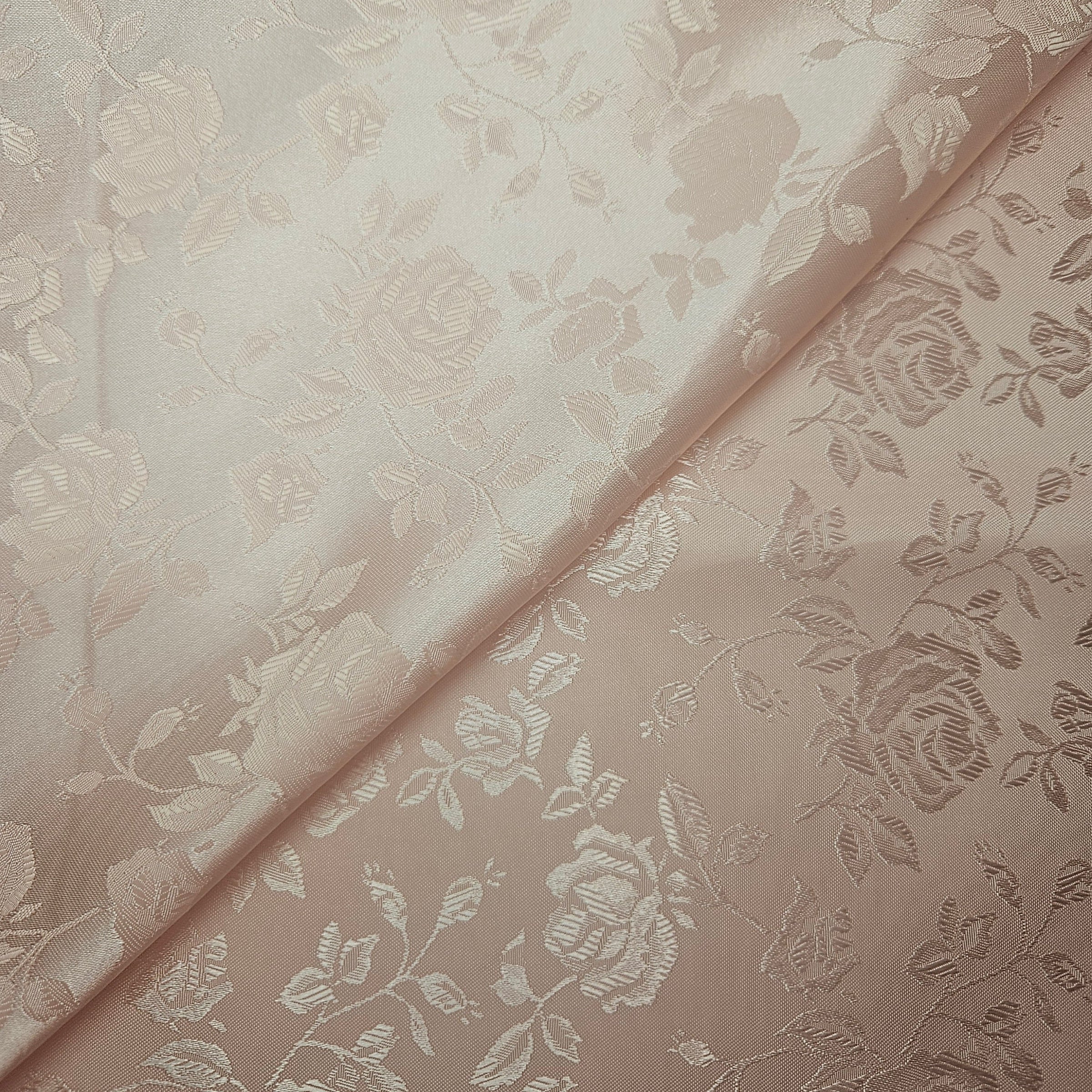 Floral patterned brocade fabric with a soft peach color palette