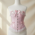 Pink floral Damask corset with decorative bows on a mannequin against a soft beige background