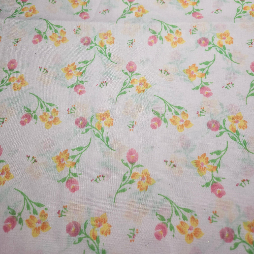 Floral pattern with pink, yellow, and green flowers on a pink background