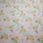 Floral pattern with pink, yellow, and green flowers on a pink background