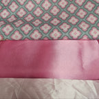 Pink fabric with a floral pattern on a gray background