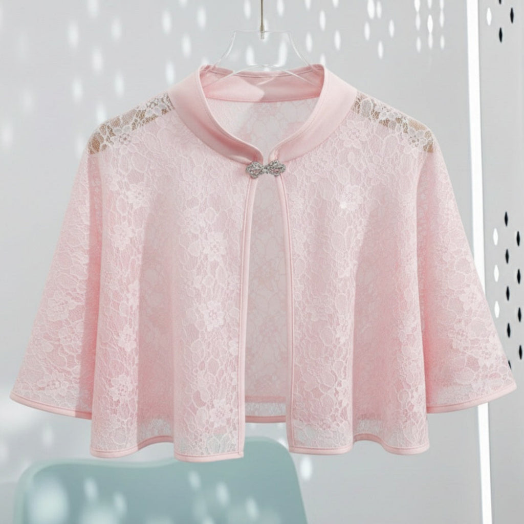 Pink lace cape with embellishments on a white background