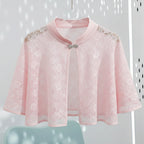 Pink lace cape with embellishments on a white background
