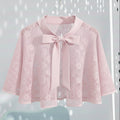 Pink lace cape with a Satin bow Tie on a light gray background