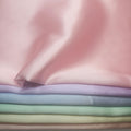 Stack of pastel-colored satin fabrics Pink