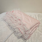 Pink lace snuggle Blanket on a white surface