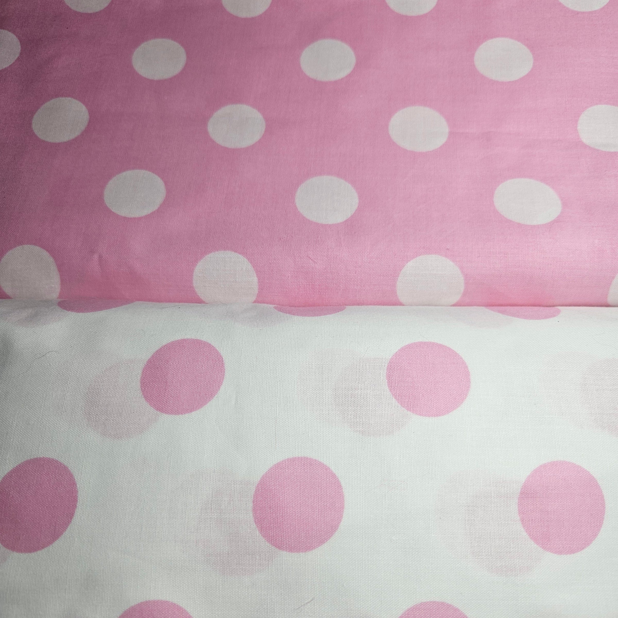 Two fabric swatches with polka dot patterns on a pink and white background.