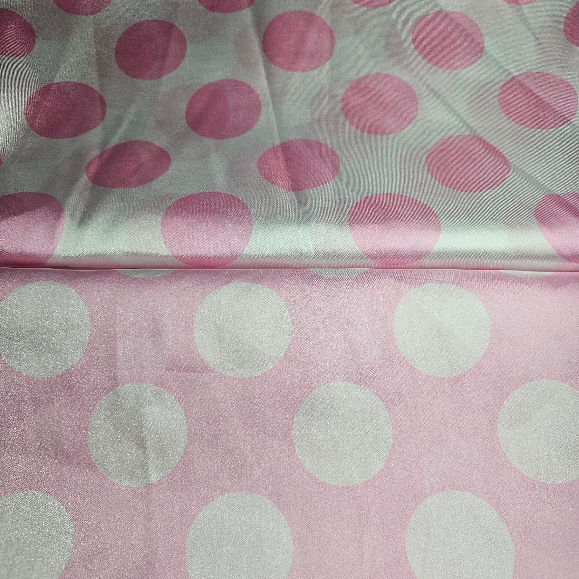Fabric with pink and white satin polka dots on a light pink background