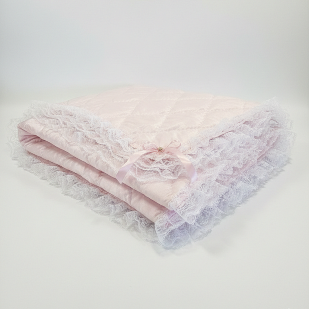 Folded pink lace blanket with a Pink satin bow with gem on a white background