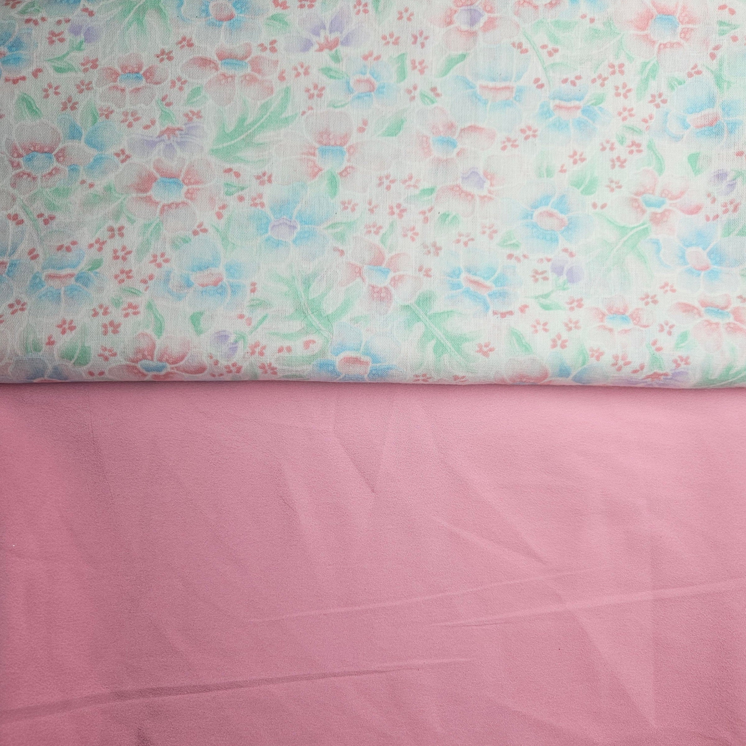 Floral patterned fabric on top of a plain pink fabric
