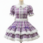 A purple and white plaid Lolita dress displayed on a mannequin. The dress features a white lace Peter Pan collar, short puff sleeves with lace trim, a white waistband, and a tiered skirt with white lace ruffles and purple bows.
