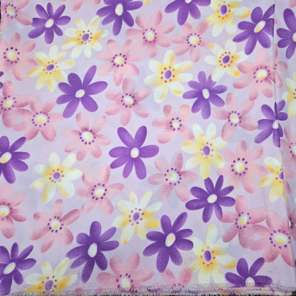 Pattern of purple, yellow, and pink flowers on a light purple background