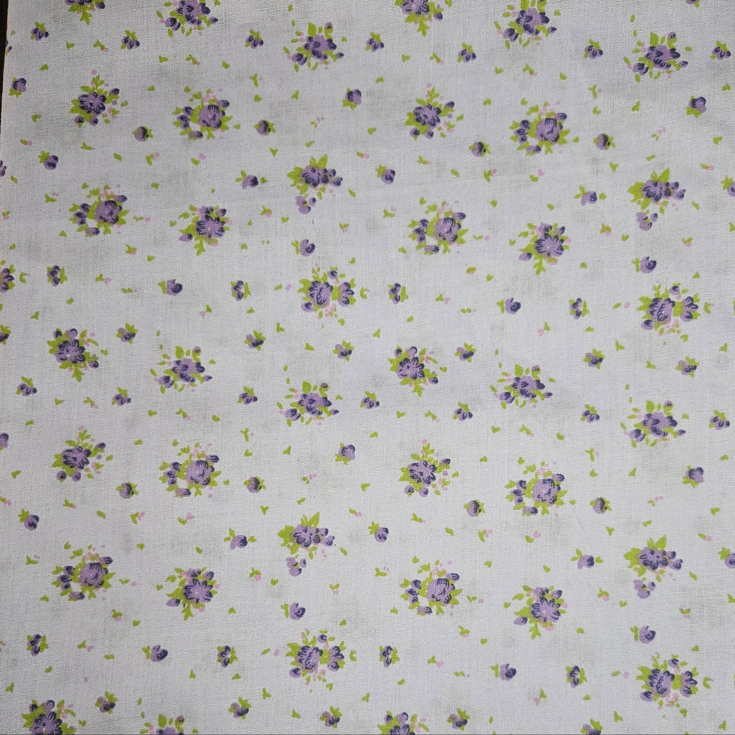 Floral pattern with purple flowers and green leaves on a lavender background