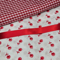 Red and white checkered fabric with red floral pattern on white background