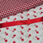 Red and white checkered fabric with red floral pattern on white background