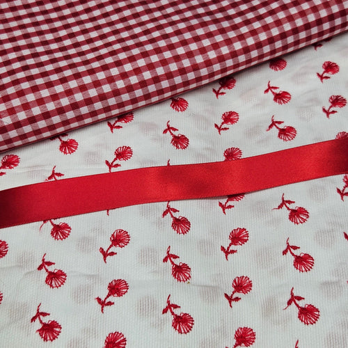Red and white checkered fabric with red floral pattern on white background