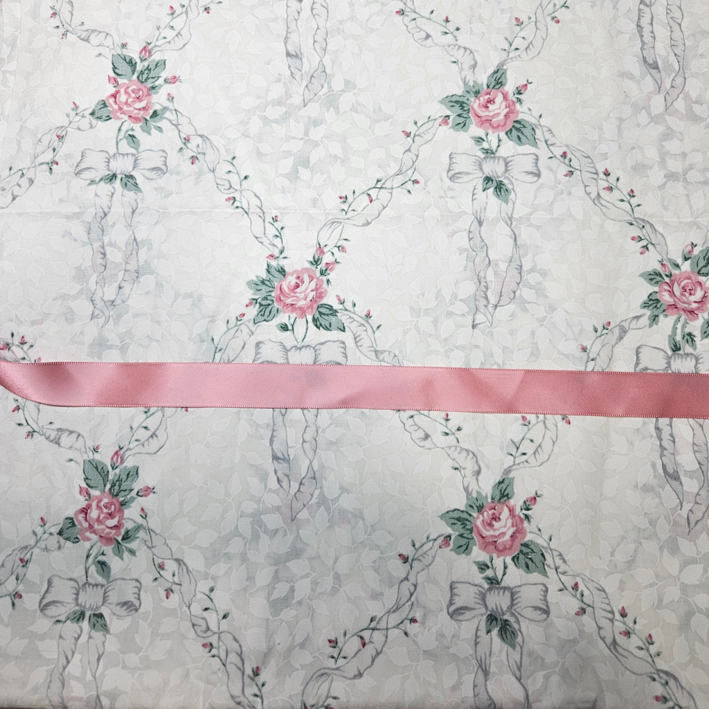 Floral and ribbon pattern with pink ribbon on a ivory background