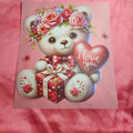 Applique with a teddy bear holding a heart and gift box on a Salmon pink background