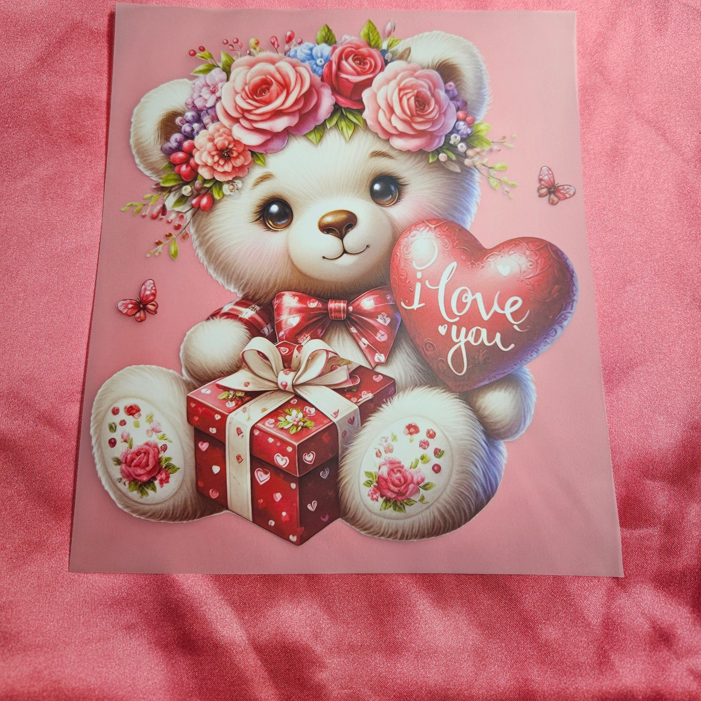 Applique with a teddy bear holding a heart and gift box on a Salmon pink background