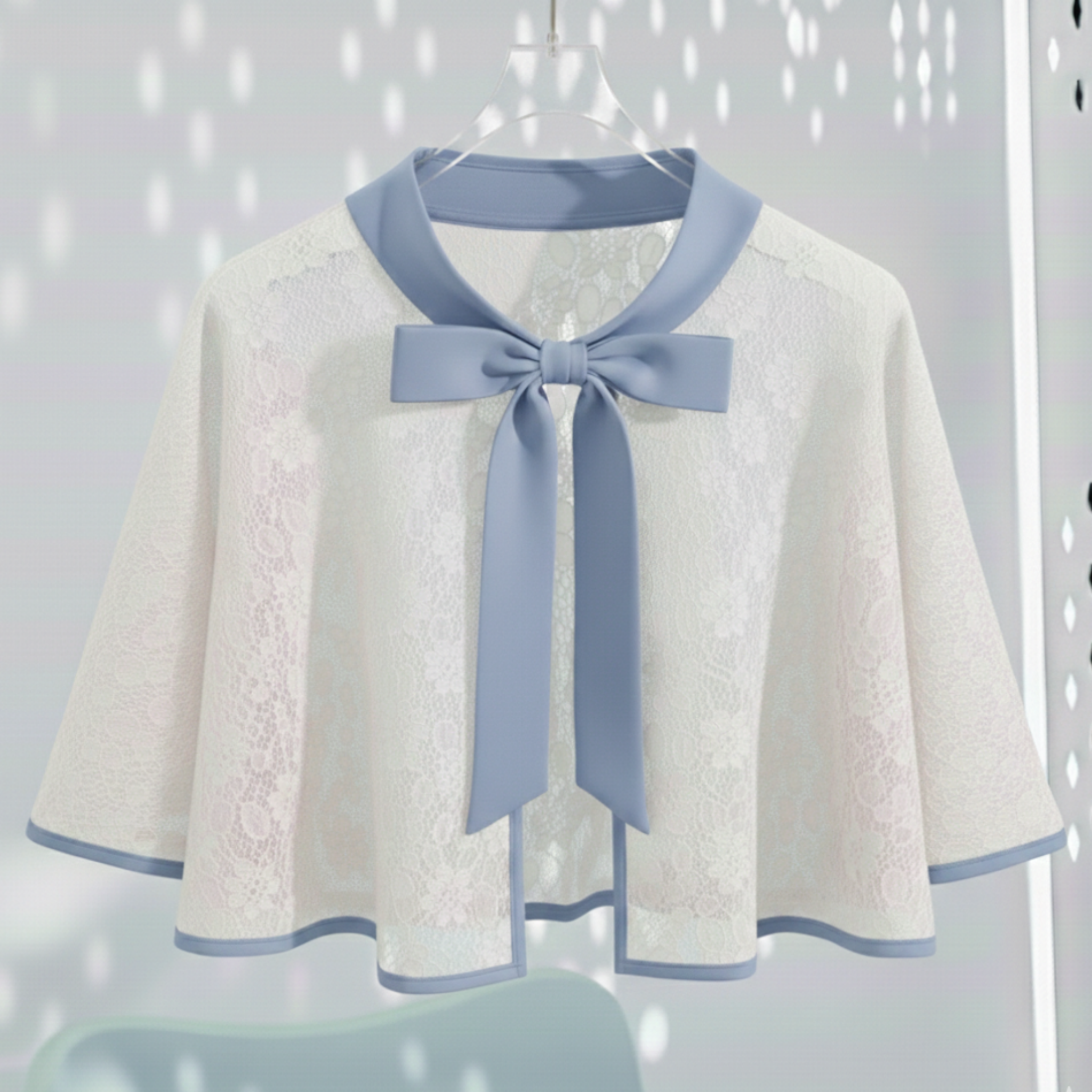 White lace cape with blue Satin bow tie on a hanger against a light gray background