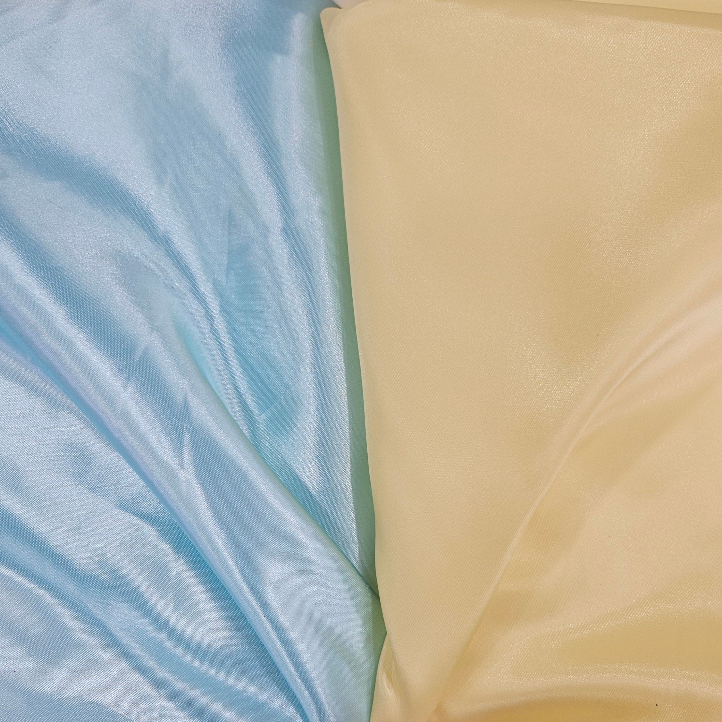 Two fabric swatches, one light blue and one yellow, side by side.